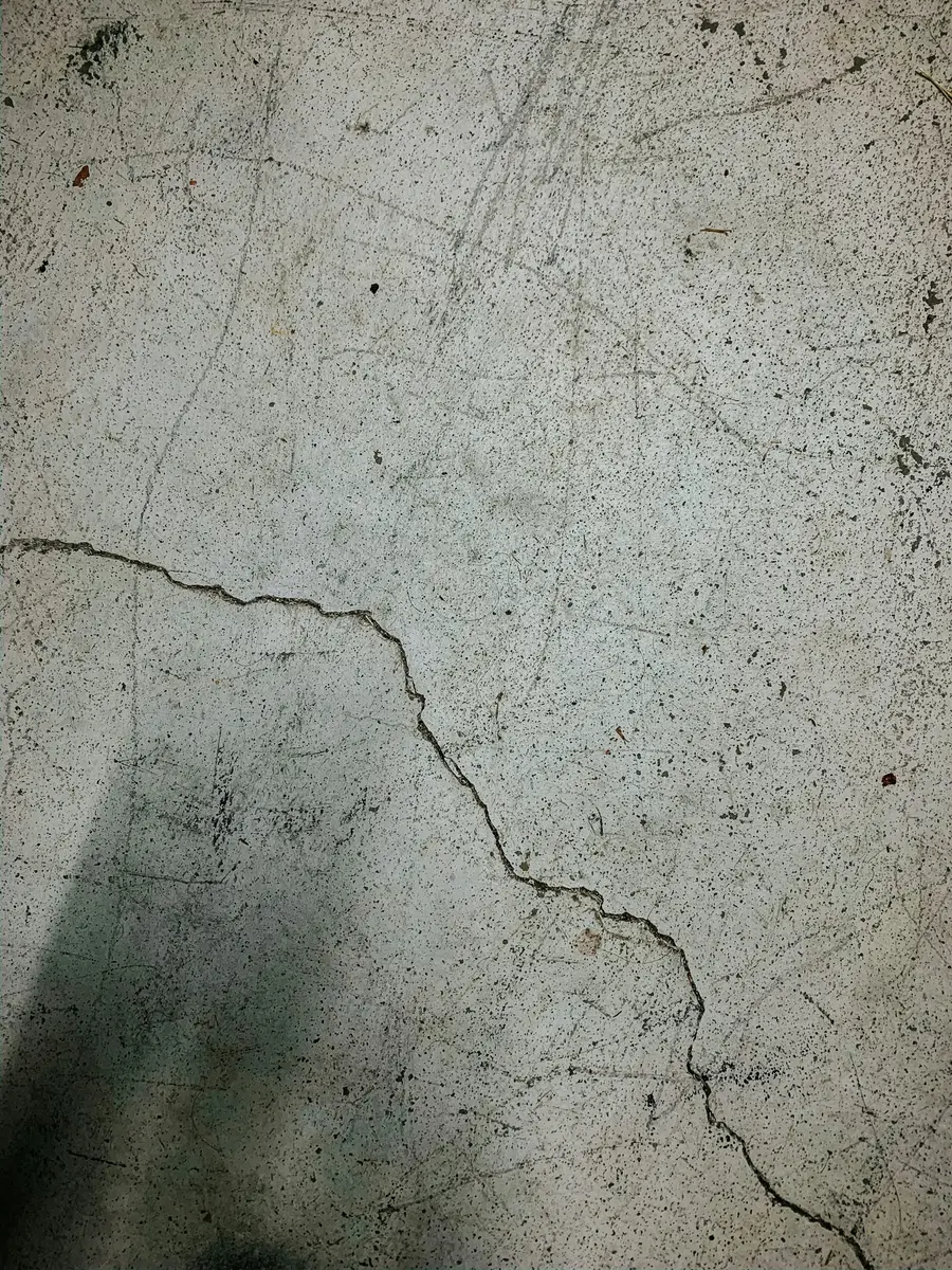 Long crack running across a bare concrete surface