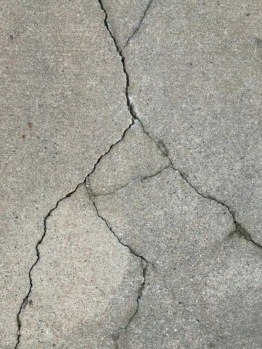 Network of cracks across a concrete floor slab