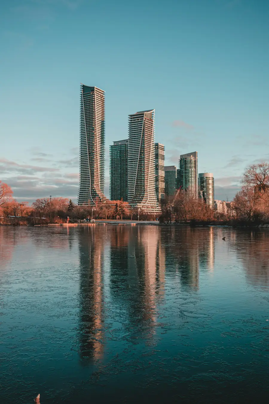 Condo towers at Humber Bay reflected in calm water at dusk